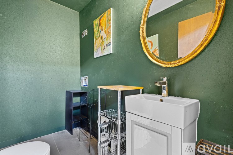 A bathroom with green walls and a white sink.