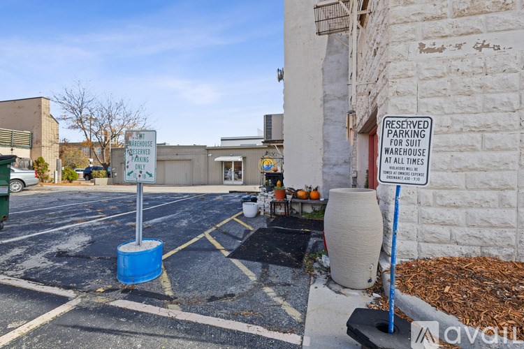 A parking lot with a sign that says "RESERVED PARKING WAREHOUSE AT ALL TIMES".