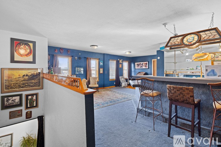 A room with a bar and chairs.