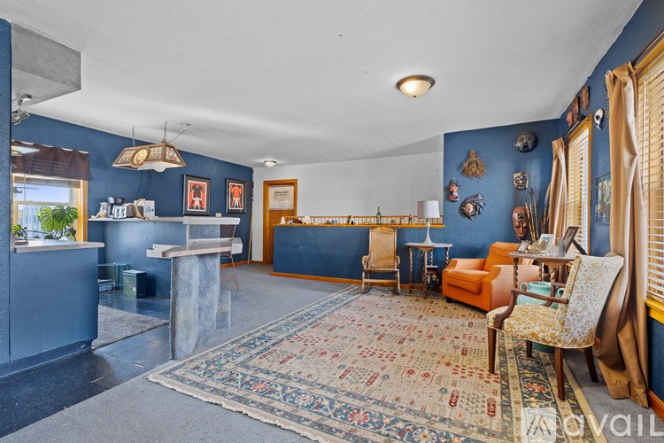 A living room with a rug and a sofa.