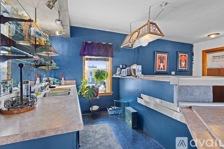 A kitchen with blue walls and wooden countertops.