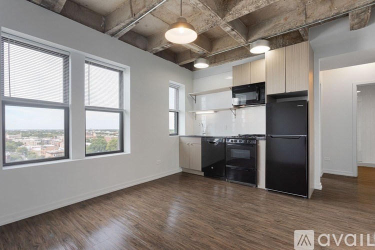 A kitchen area with a black fridge, black oven, and black microwave.