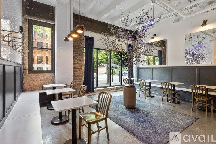 A modern dining area with wooden chairs and tables.