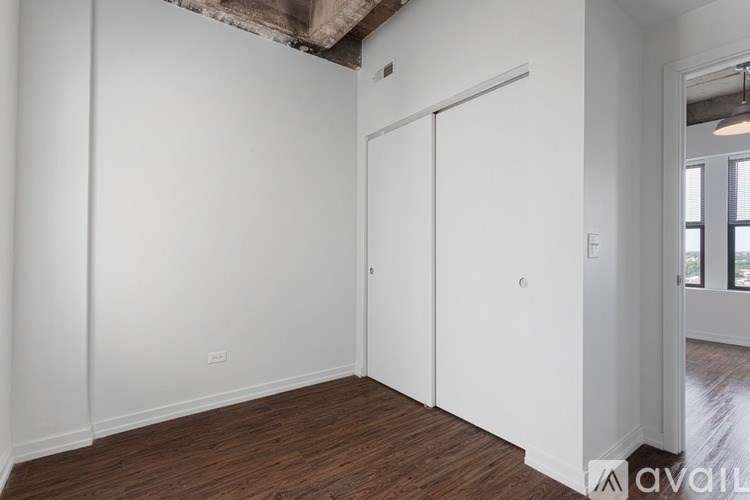 A room with a white door and a window.