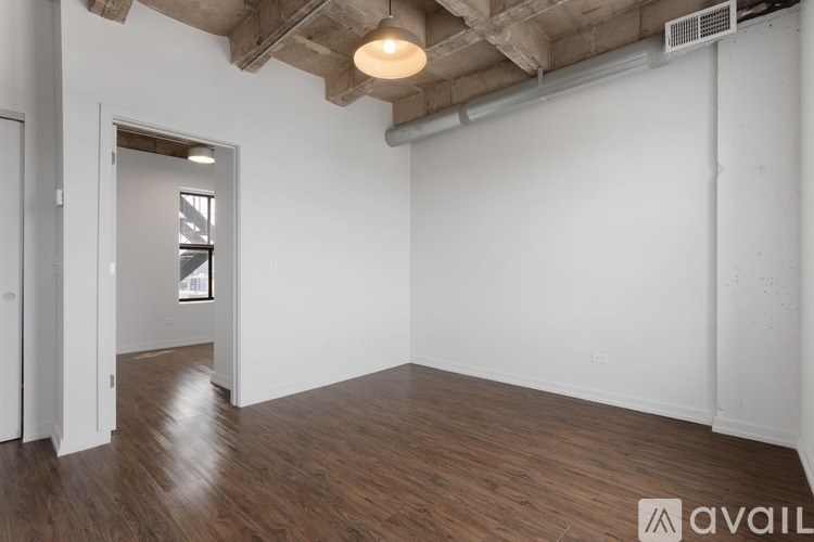 A room with wooden floors and a ceiling light.