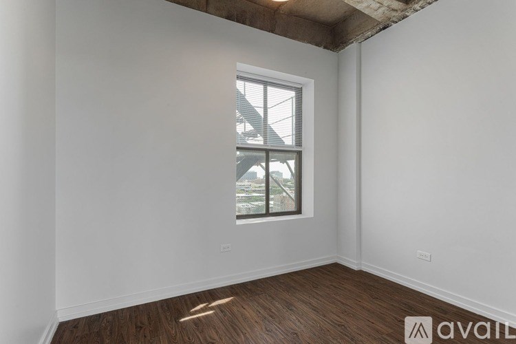 A room with a window and wooden flooring is available for rent.