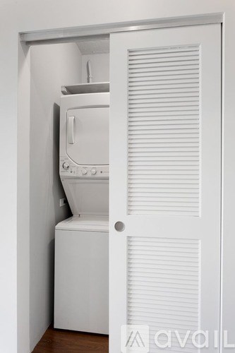 A white oven is installed in a white cabinet.