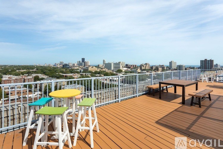 A wooden deck with a table and chairs overlooking a city skyline.