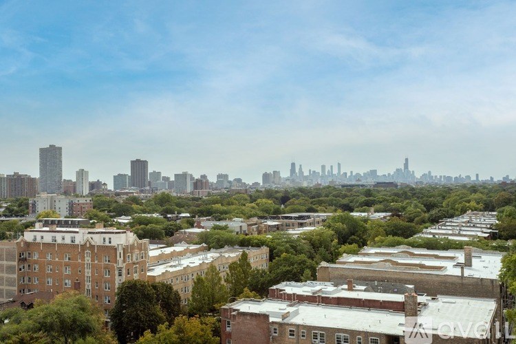 A cityscape with buildings and trees in the foreground.
