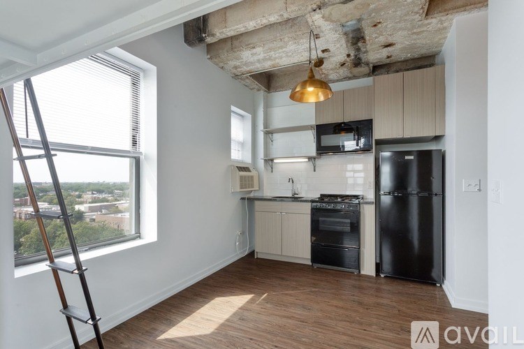 A kitchen with a black fridge and a black oven.
