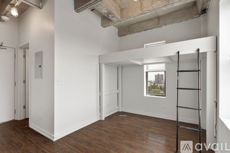 A room with a ladder and a window showing a city view.