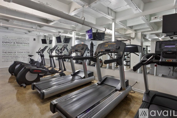 A gym with treadmills and elliptical machines.