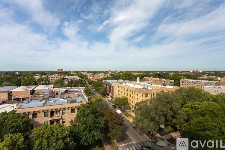 A bird's eye view of a city street with buildings and trees.