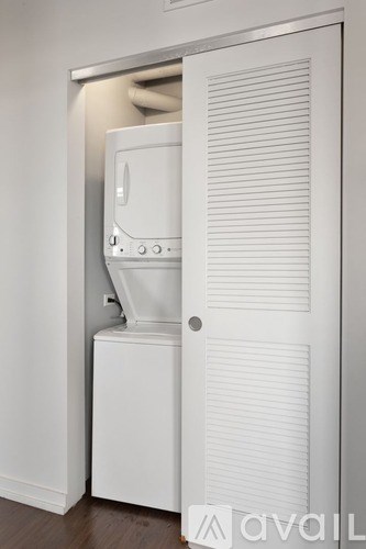 A white toilet is installed in a wall.