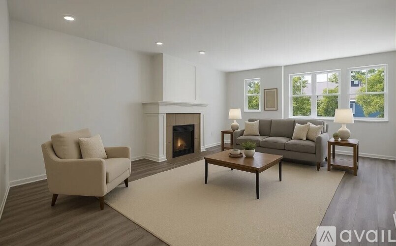 A living room with a fireplace, a couch, a chair, and a coffee table.