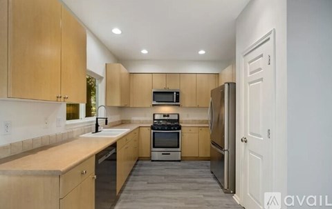 A kitchen with wooden cabinets and stainless steel appliances.
