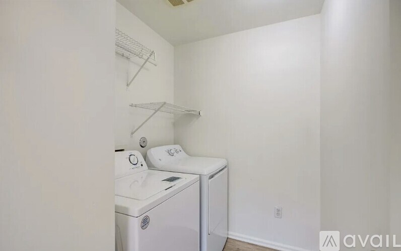 A small laundry room with a washer and dryer.