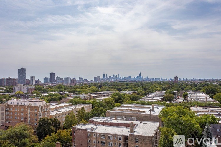 A cityscape with buildings and trees in the foreground.
