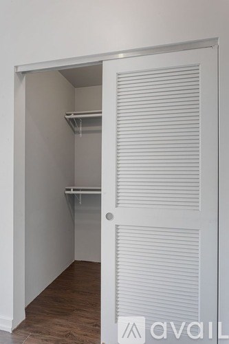 A white door with a shelf underneath it.
