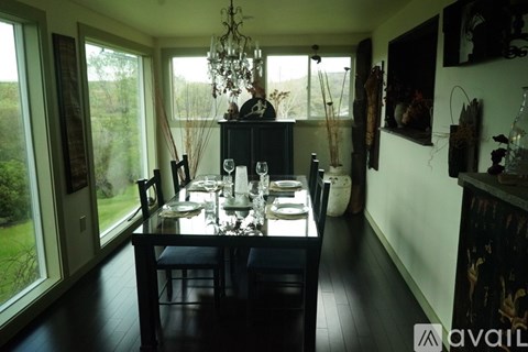 A dining room with a table set for a meal.