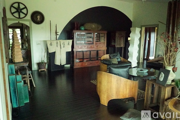 A room with a lot of furniture and a mirror on the wall.