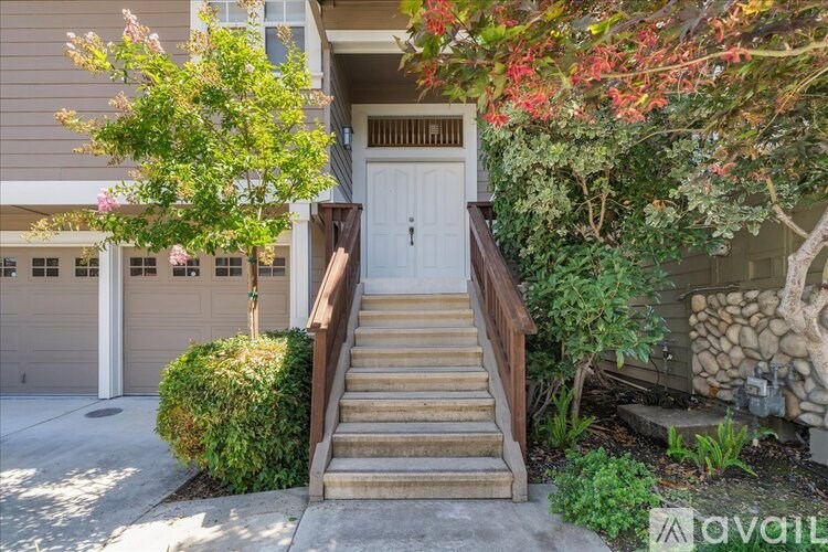 A house with a white door and a staircase leading to it.