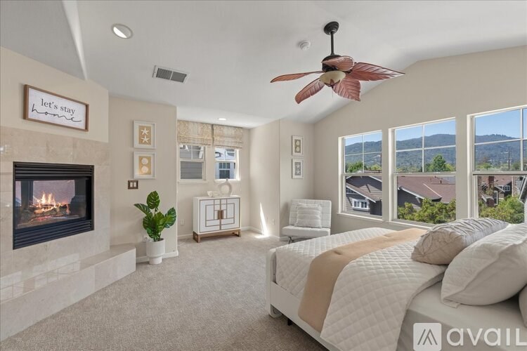 A bedroom with a fireplace and a bed.