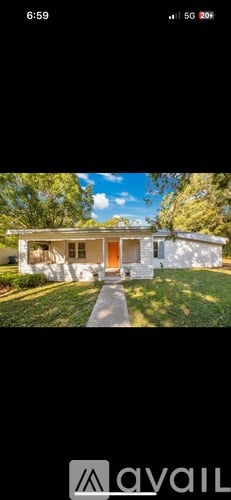 A white house with a red door is shown in the image.