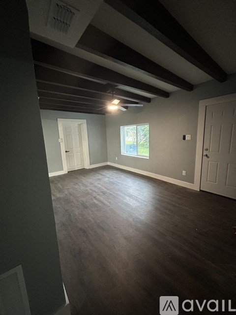 A room with wooden floors and white walls.