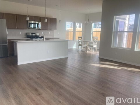 A kitchen with wooden floors and white countertops.