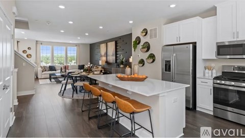 A modern kitchen with white cabinets and a center island.