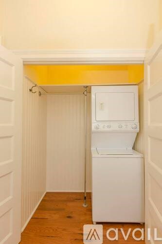 A small laundry room with a washer and dryer.