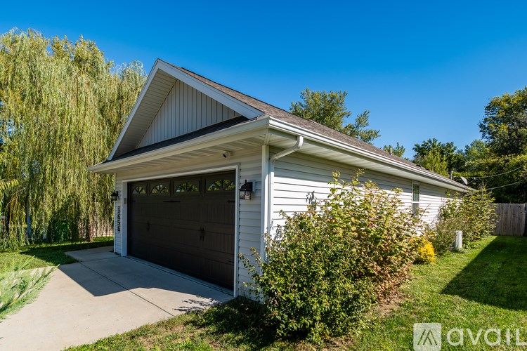 A two-car garage with a white exterior and a grey roof.