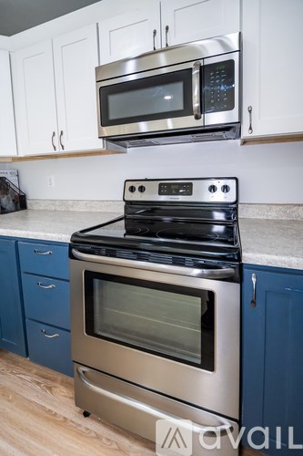 A modern kitchen with a stainless steel oven and microwave above it.
