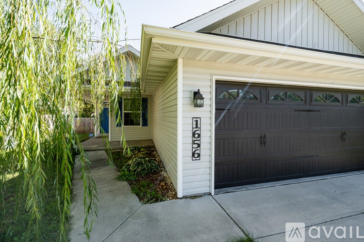 A house with a garage door that has the numbers 16556 on it.