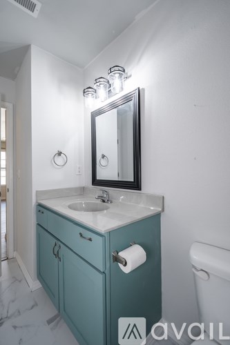 A bathroom with a sink and a mirror.