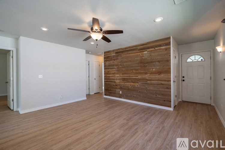 A room with wooden floors and a ceiling fan.