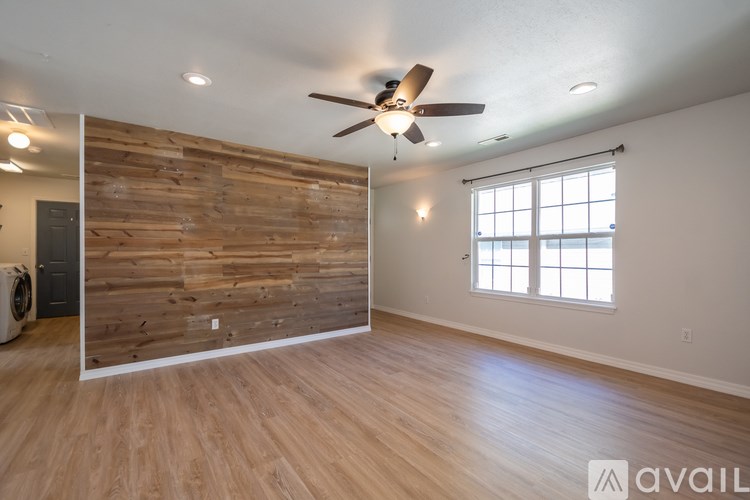 A room with wooden walls and a ceiling fan.