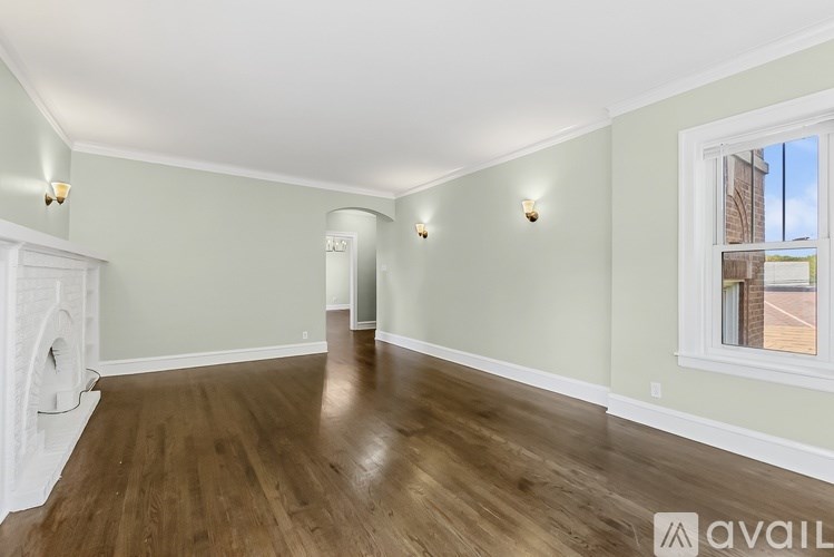 A room with wooden floors and white walls.