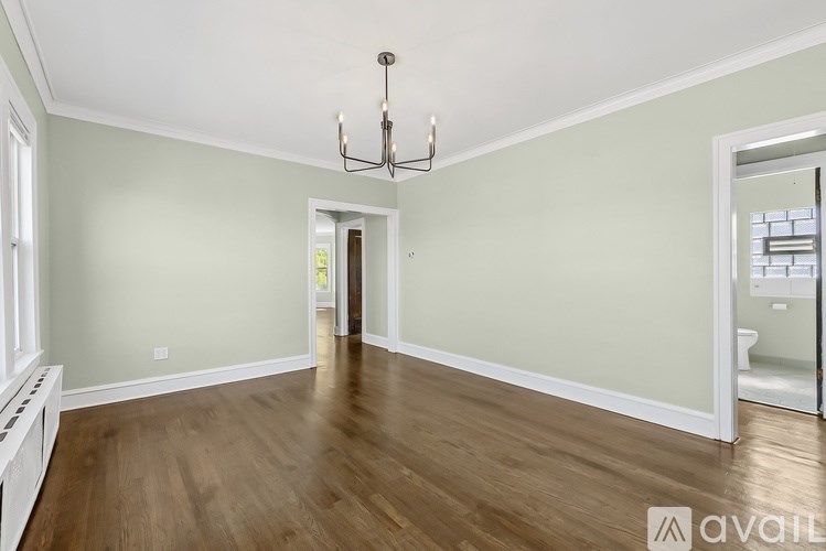 A room with wood floors and a chandelier.