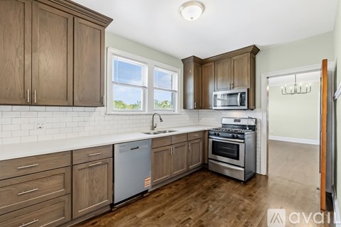 A kitchen with wooden cabinets and a white countertop.