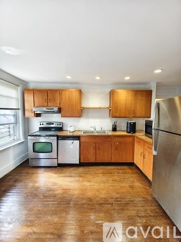 A kitchen with wooden cabinets and stainless steel appliances.
