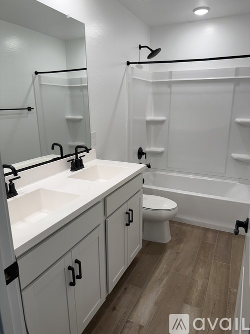 A bathroom with a white sink and toilet.