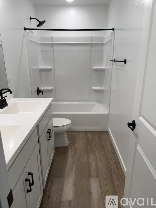 A bathroom with a toilet, sink, and walk-in shower.