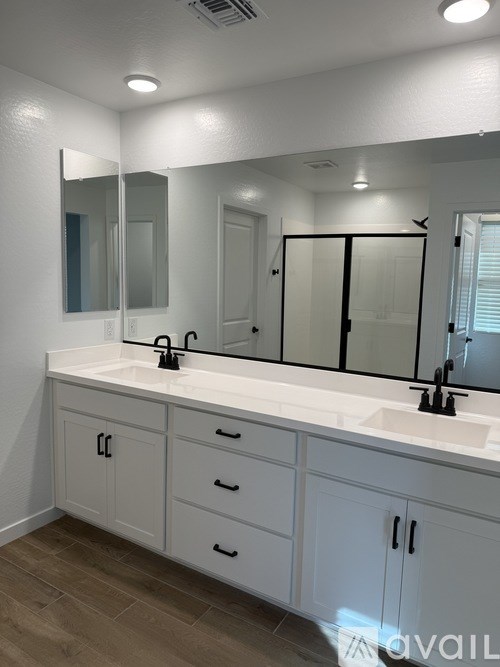 A bathroom with a white counter and a large mirror.