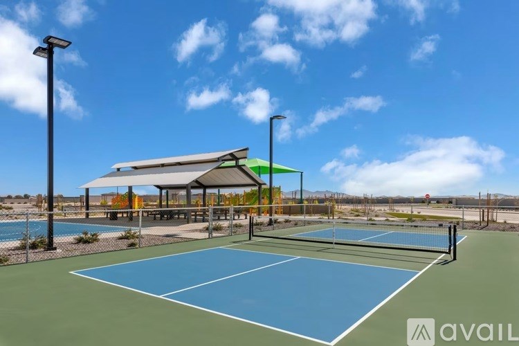A tennis court with a blue surface and a white net.