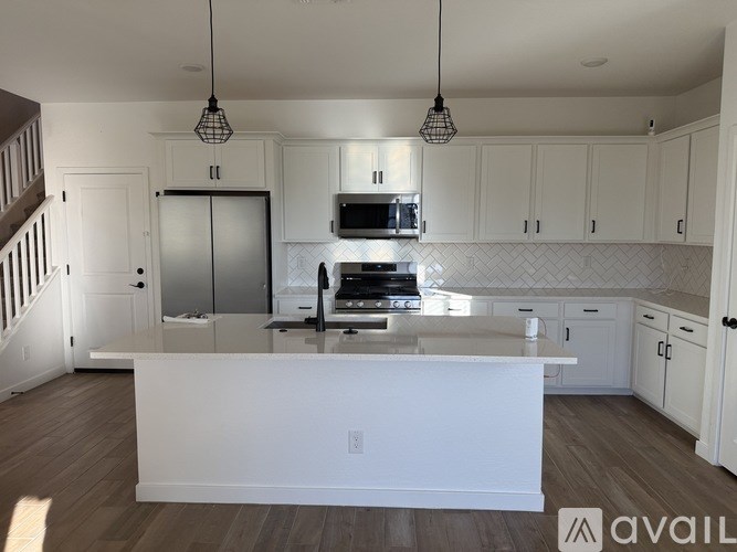 A modern kitchen with white cabinets and a central island.
