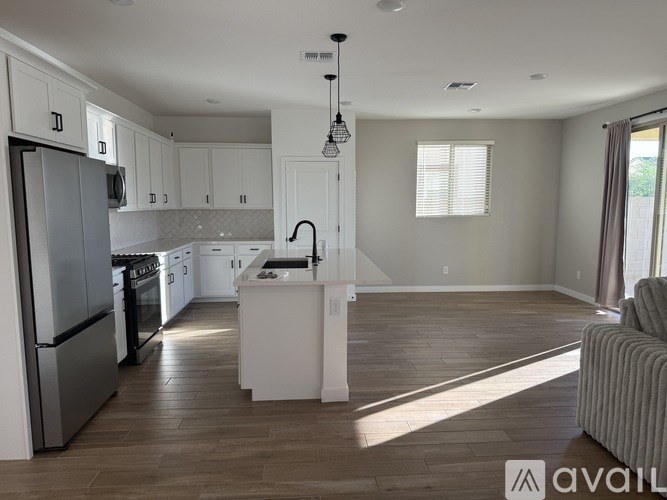 A modern kitchen with white cabinets and a large island.