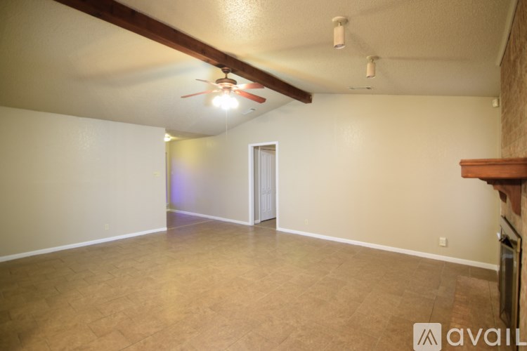 A room with a ceiling fan and a door.