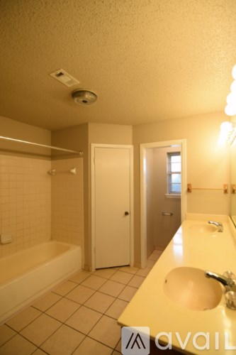 A bathroom with a white tub and sink.